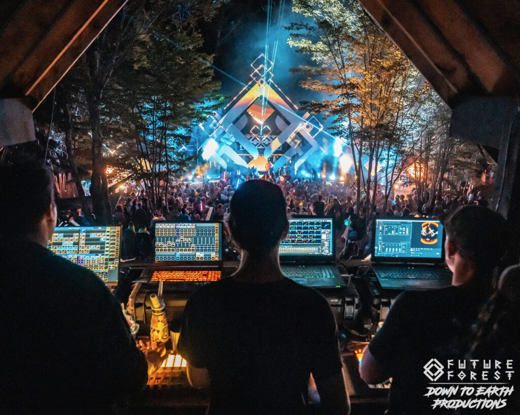Sound and lighting crew working the booth inside the forest stage